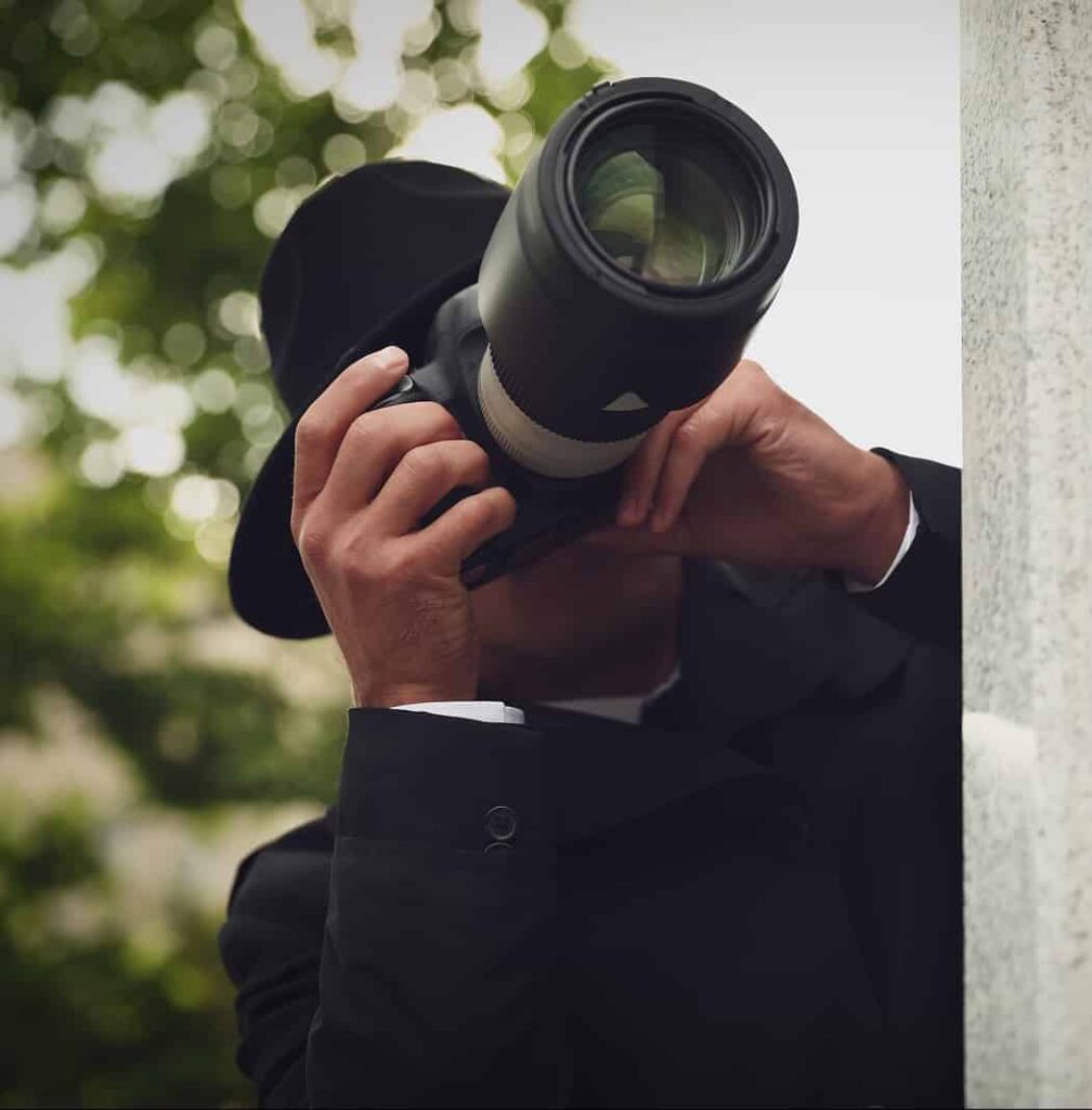 Private Detective With Modern Camera Spying On City Street