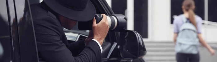 Private Detective With Camera Spying From Car
